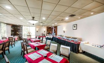 a conference room set up for a meeting , with tables and chairs arranged in rows at Chester Hotel and Conference Center