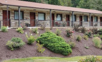 a row of multiple small houses with balconies , situated next to each other on a hill at Jefferson Hills Motel