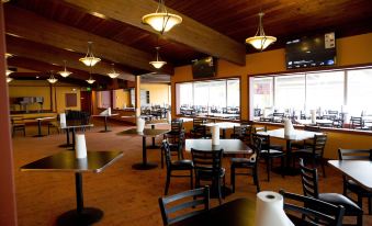 a large dining room with multiple tables and chairs arranged for a group of people to enjoy a meal together at Indiana Beach Accommodations