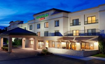 "a large building with the words "" courtyard by marriott "" prominently displayed on the front" at Courtyard Newburgh Stewart Airport