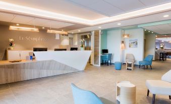 a modern hotel lobby with a reception desk and several chairs arranged around it , creating a welcoming atmosphere at Best Western Hotel le Semaphore