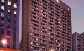 "a large , modern building with the name "" stamford "" on it , illuminated at night against a purple sky" at Stamford Plaza Adelaide