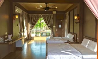 a hotel room with two beds , one on the left and one on the right side of the room at The Waterway Villa