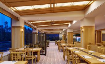 a large dining room with wooden tables and chairs arranged for a group of people to enjoy a meal at The Westin Rusutsu Resort
