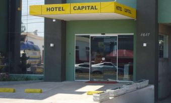 "the entrance of a hotel called "" hotel capital "" with its name displayed above the door , and a parking lot in front of it" at Hotel Capital