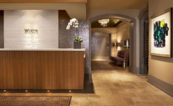 a modern office interior with wooden walls , stone accents , and a reception desk decorated with flowers at Dossier