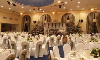 a large banquet hall filled with tables and chairs , ready for a wedding reception or other special event at Park