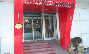 "the entrance of a red building with the words "" hotel 4 mostar "" on it , decorated with stars" at Mostar Hotel