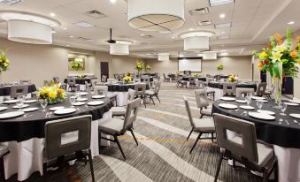 a large dining room with multiple tables and chairs set up for a formal event , possibly a wedding reception at Courtyard Columbus Phenix City/Riverfront