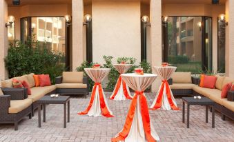 a patio area with several tables and chairs arranged for an event , possibly a wedding reception at Courtyard by Marriott Las Vegas Convention Center