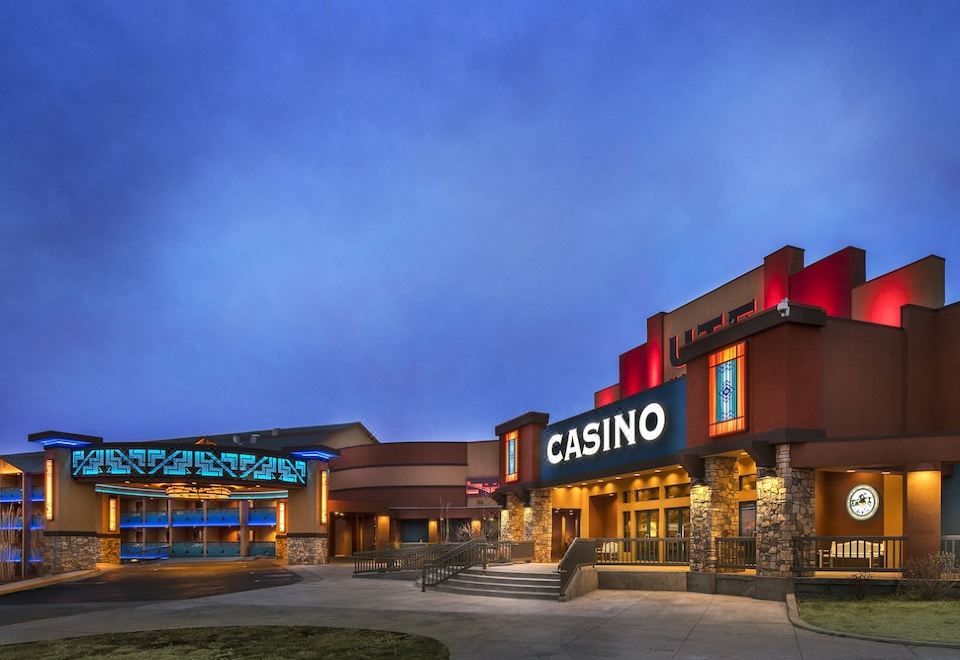 a large building with a red roof , possibly a casino or a hotel , located in a city at Ute Mountain Casino Hotel