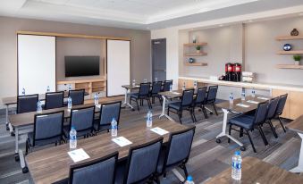 a conference room with several rows of chairs arranged in a semicircle around a table at Hyatt House Charleston/Mount Pleasant
