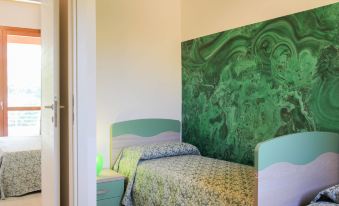 a small room with two beds , one on top of the other , and a green wall at Dora