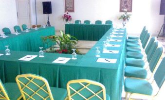 a conference room set up for a meeting , with chairs arranged in a semicircle around a table at Resor Tuban Tropis