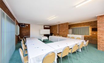 a conference room with a long table and chairs , set up for a meeting or presentation at Thurgoona Country Club Resort