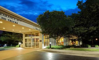 "a large building with a sign that reads "" holiday inn "" is shown at night" at Hilton Garden Inn Chesterton