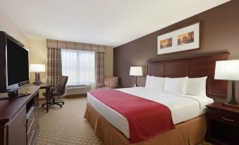 a hotel room with a king - sized bed , a flat - screen tv , and a window with curtains at Country Inn & Suites by Radisson, Ashland - Hanover, VA