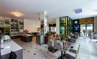 a modern restaurant with white marble floors , black and white checkered floors , and a large dining table surrounded by chairs at Soho Boutique Hotel