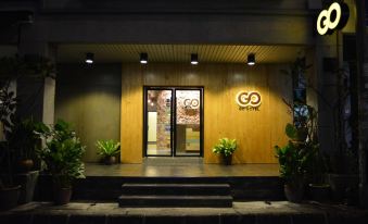 "a hotel entrance with a wooden door and a sign that reads "" go "" on it" at Go Hotel
