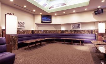 a large room with multiple couches and chairs arranged in various positions , creating a comfortable seating area at Hakodate-Onuma Prince Hotel