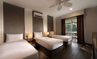 a hotel room with three beds , one on the left , one in the middle , and one on the right at Perhentian Island Resort