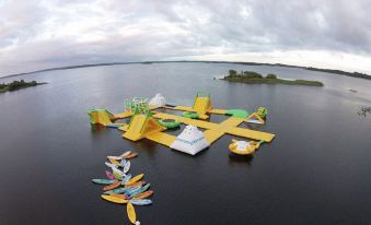 an aerial view of a large body of water with various water toys floating on it at The Prince of Wales Hotel