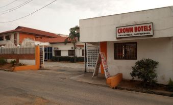 "a motel with a sign that reads "" crown motel "" is shown on a street corner" at Crown Hotel