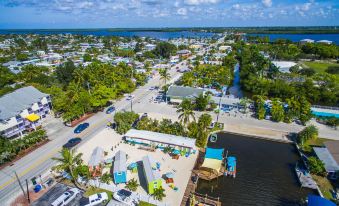 aerial view of a residential area near the ocean , with multiple houses and boats docked on the waterfront at Matlacha Tiny Village