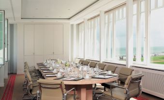 a large conference room with a long table and multiple chairs arranged for a meeting at Grand Hotel Heiligendamm - the Leading Hotels of the World