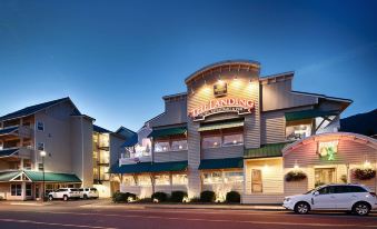 "a large building with a sign that reads "" renaissance suites "" prominently displayed on the front of the building" at The Landing Hotel