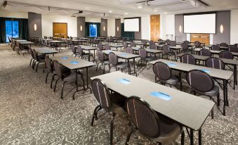 a large conference room with multiple rows of tables and chairs arranged for a meeting or event at Aloft Mount Laurel