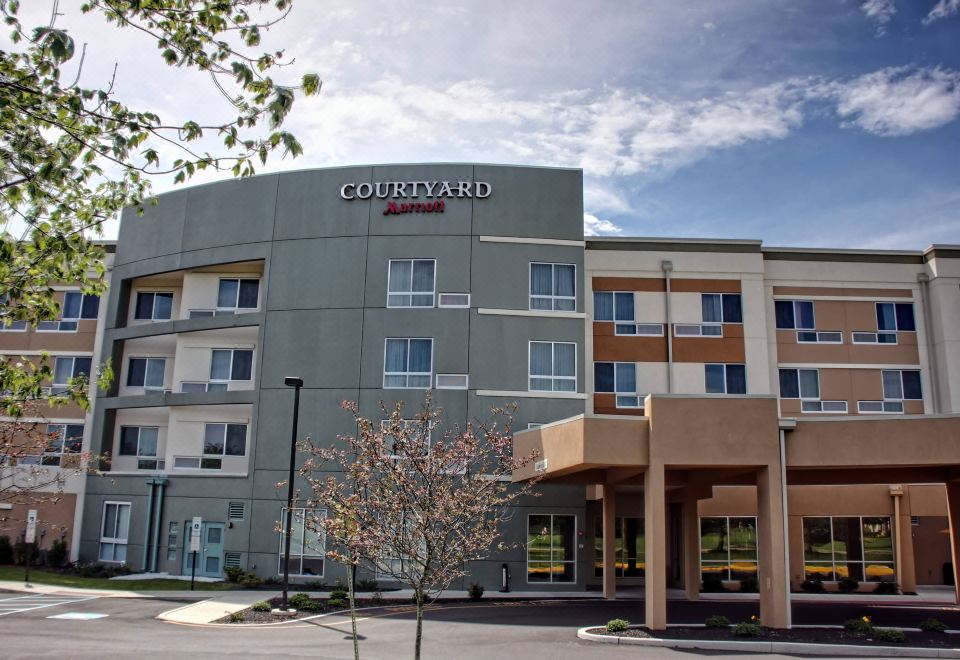 a courtyard by marriott hotel with a large sign on the side of the building at Courtyard Philadelphia Bensalem