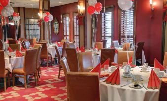 a large dining room filled with tables and chairs , all set for a special occasion at The Gibside Hotel