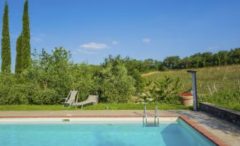 a swimming pool surrounded by lush greenery , with a view of the surrounding countryside at Arco