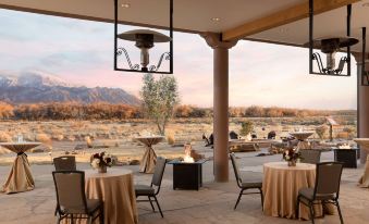 an outdoor dining area with tables and chairs set up for a meal , surrounded by a desert landscape at Hyatt Regency Tamaya Resort and Spa
