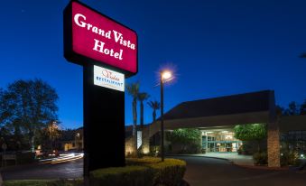 "a hotel entrance with a large sign that reads "" grand vista hotel "" prominently displayed on the building" at Grand Vista Hotel
