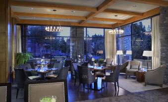 a dining room with tables and chairs arranged for a group of people to enjoy a meal together at Oswego Hotel