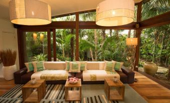 a large living room with multiple couches and chairs arranged in a sitting area , creating a cozy atmosphere at Arajilla Retreat