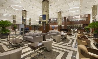 a modern hotel lobby with various seating options , including couches and chairs , and a bar at DoubleTree by Hilton Istanbul-Avcilar