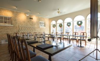 a dining room with several tables and chairs arranged for a group of people to enjoy a meal together at The Little Inn of Bayfield