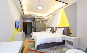 The room features a large bed and two wall-mounted televisions in a color scheme of white and brown at Muge Hotel
