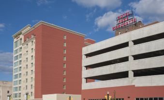 a red and white building with a sign on top , possibly a parking garage or a hotel at Courtyard Peoria Downtown