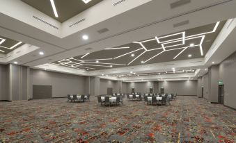 a large , empty conference room with multiple tables and chairs set up for meetings or events at Courtyard Austin Pflugerville and Pflugerville Conference Center