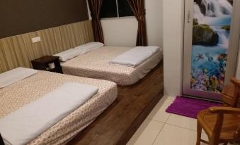 a hotel room with two beds , one on the left and one on the right side of the room at Muar Golden Horse Hotel