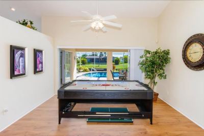 a large pool table in a living room with a view of a swimming pool at Italy