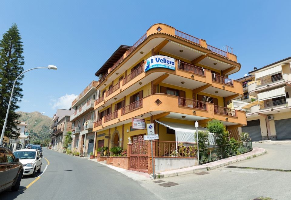 "a yellow two - story building with balconies and a sign that says "" la valle "" on it" at Il Veliero