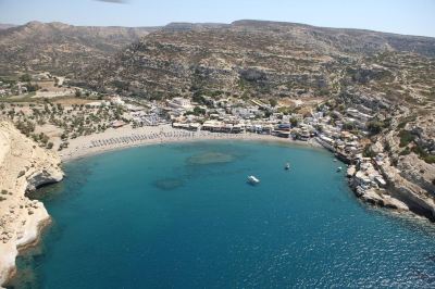 aerial view of a small town by the sea , with a beach visible in the distance at Valley Village