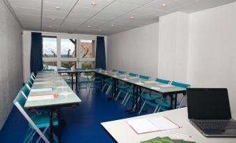 a large conference room with multiple tables and chairs arranged for a meeting or event at Belambra Clubs Montpezat - le Verdon