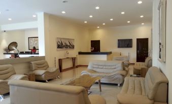 a large room with multiple couches and chairs arranged in a seating area , possibly for a conference or event at Hotel Oceano