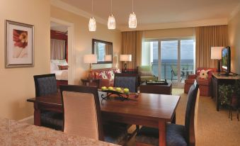 a dining room with a wooden dining table , chairs , and a view of the ocean at Marriott's Oceana Palms